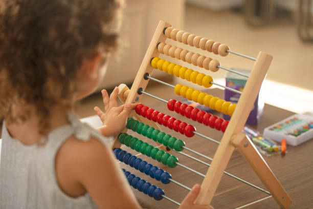 istock Little girl with abacus. children math education concept 1279799488