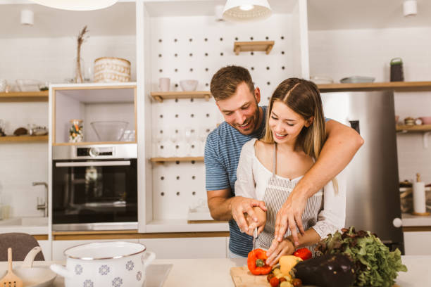 istock Young couple cooking together in kitchen 1279799503