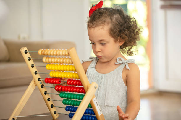 istock Little girl with abacus. children math education concept 1279799529