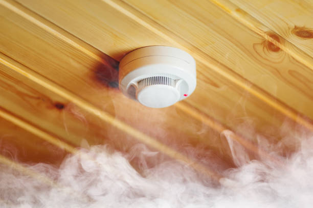 smoke detector in wooden house, fire alarm in action smoke detector in wooden house, fire alarm in action, dense smoke fire alarm smoke detector smoke danger stock pictures, royalty-free photos & images