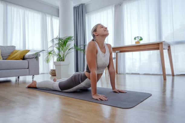 istock Beautiful active young woman practicing yoga at home. 1279800647