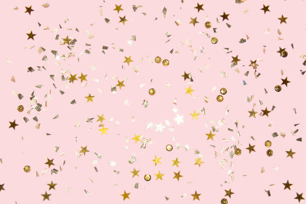 istock gold shiny flying confetti on a pink background festive backdrop 1279800860