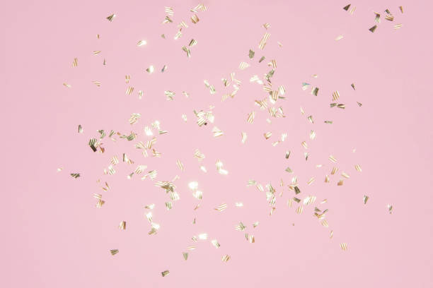 istock gold shiny flying confetti on a pink background festive backdrop 1279800873