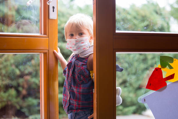 istock Child, putting medical protective mask before entering kindergarten 1279801148