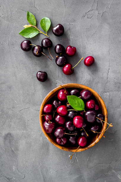 istock Berries in the bowl. Red cherry top view, copy space 1279802082