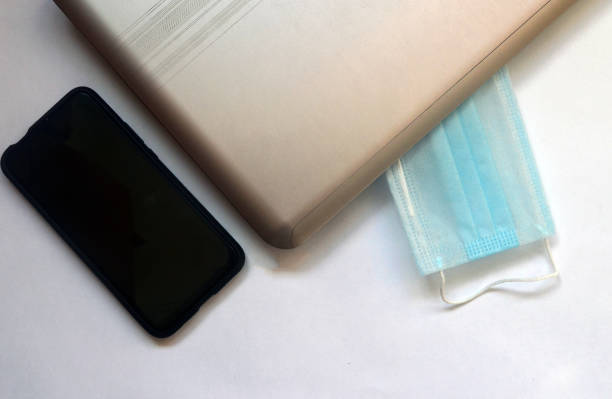 istock Stop coronavirus. Protective mask, laptop and smartphone on a white background. 1279802869