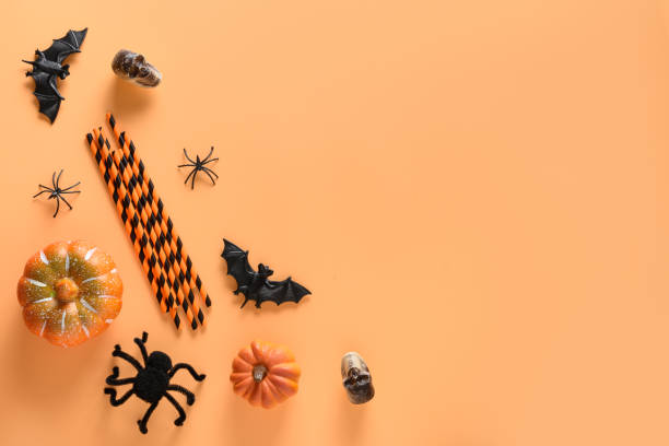 istock Halloween fun party decorations, pumpkin, drinking straw, bat, spooky spider. Top view, flat lay. Copy space. 1279804096