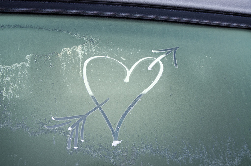 Heart drawn on a frosted car window