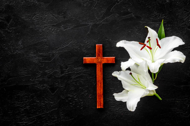 istock Lily funeral flower with cross. Condolence card with copy space 1279804848