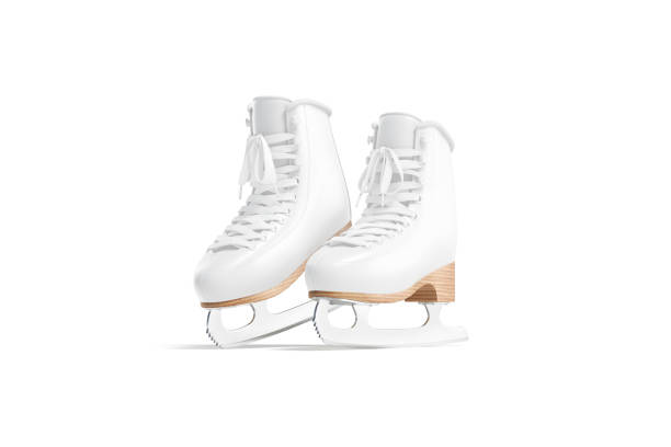 A close-up of a girl's hand holding ice skates at a skating rink.