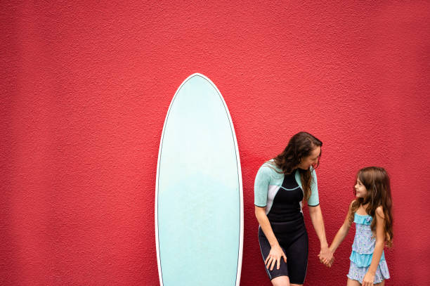 istock Female surfer with her daughter 1279805168