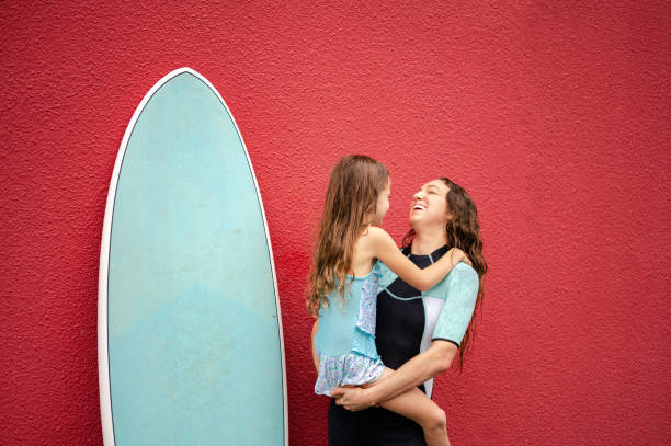istock Female surfer with her daughter 1279805175