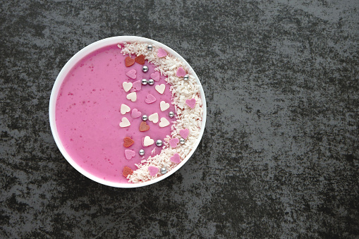Purple Smoothie Bowl for Valentine's Day. Breakfast bowl with smoothies and decorations Valentines.