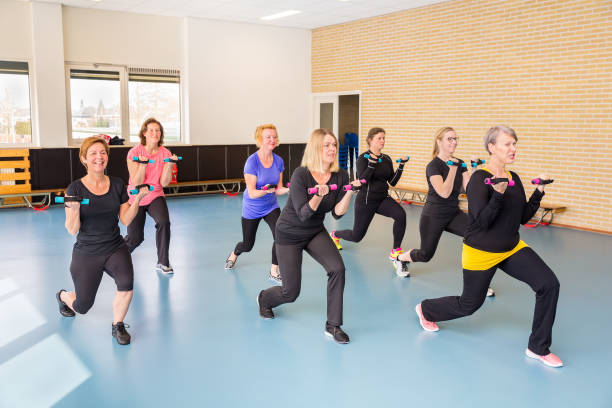 istock Group of women in gym class holding weights 1279806513