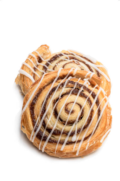 Freshly baked traditional cinnamon swirls isolated on white