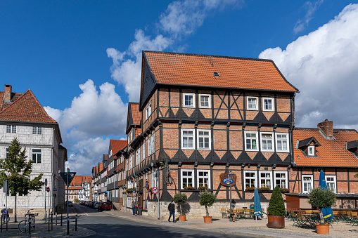 A sight seeing train with tourist passes the Saint Jacob's church (Jakobus Kirche) at the Sources square (Brunnen Platz) in Rüdesheim am Rhein.