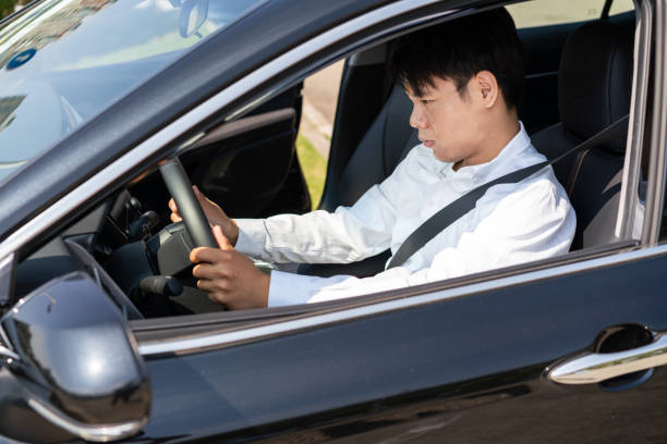 istock Young man trying out his new car 1279808395