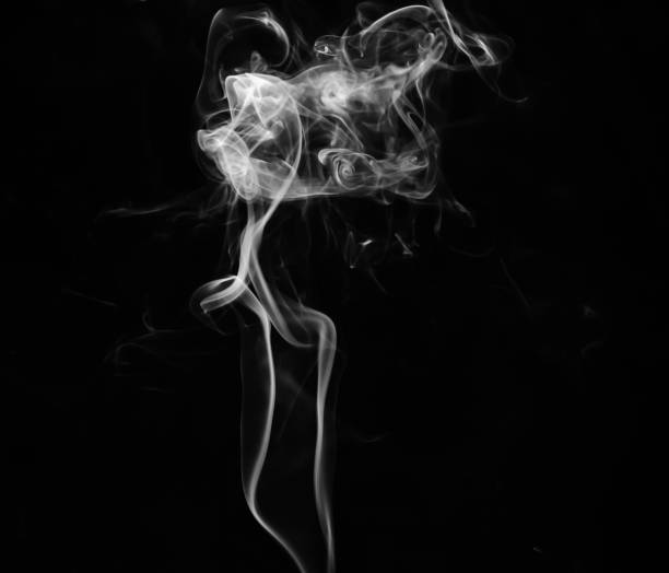 istock abstract fragment movement of white smoke on black background. 1279808412