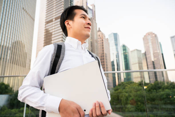 istock Young man walking in business district 1279811857