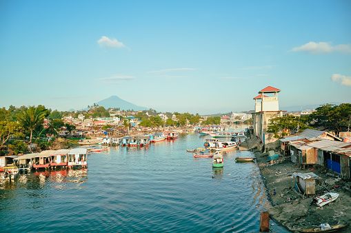 Port Manado, manado bay with some ferry boat, background Klabat Mount