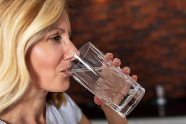 istock Mature Woman drinking water. 1279813900