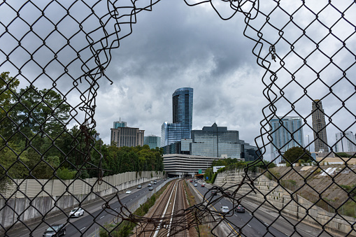 Buckhead Atlanta visible through a fence on an overcast day