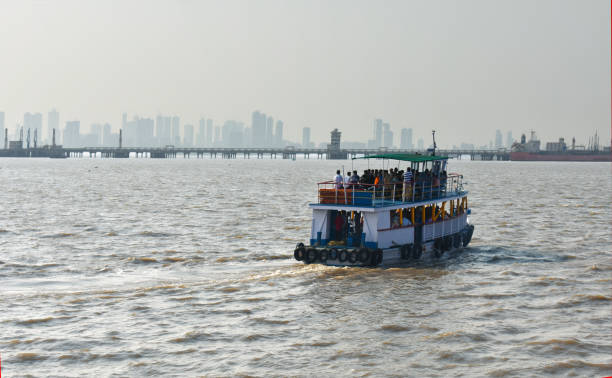 a boat returning to mumbai port with passengers