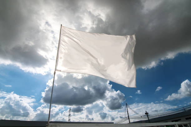 istock White flag waving over the cloudy sky 1279816391