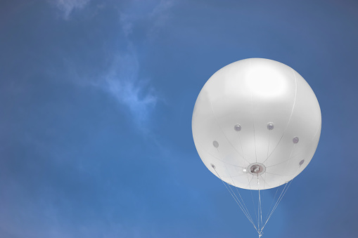 White helium balloon over sky with empty space for advertising