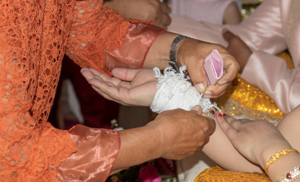 istock The elderly hand tied the thread to the bride. 1279817872