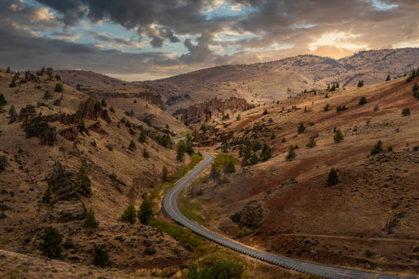 The sun shining after a storm on a lonely road in the desert on Warm Springs Indian Reservation in Central Oregon.