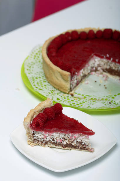 istock Levington sliced cake with raspberry jelly, chocolate and coconut. Garnished with raspberries. 1279818600