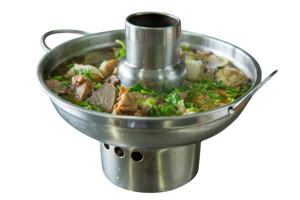 Die cut chinese clear soup with boiled entrails and vegetables, served in a metal hot pot