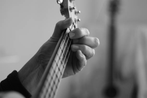 istock Close up of hands playing the ukulele 1279820754