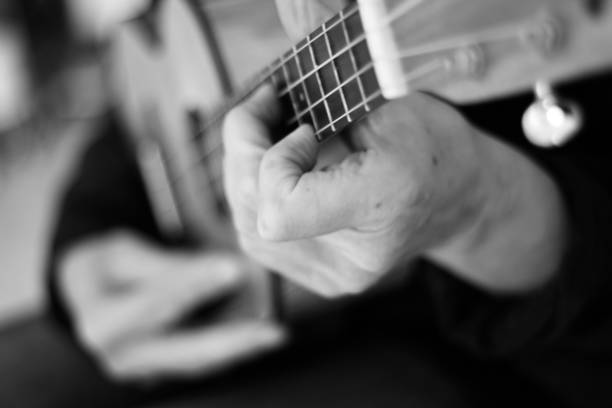 istock Close up of hands playing the ukulele 1279820761