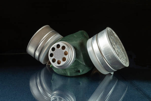 Raspirator with valve on table with reflection on black background.Means of protection for breathing