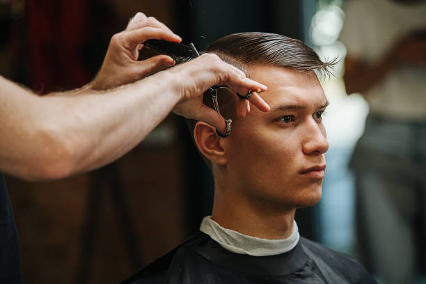istock Self-respecting serious young man in a barber shop 1279823517