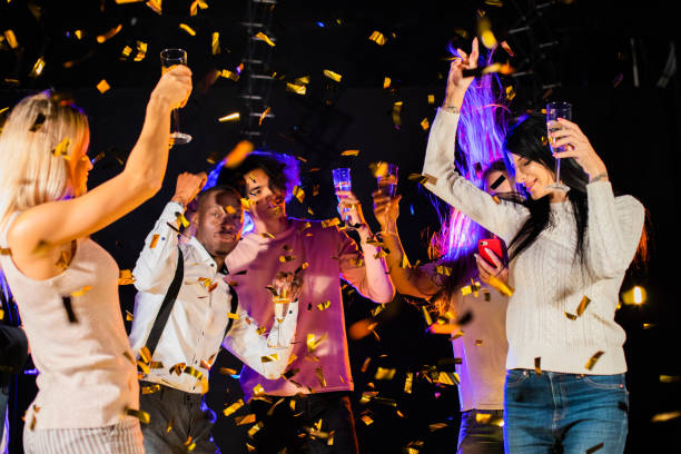 istock Happy people dance in confetti 1279827401