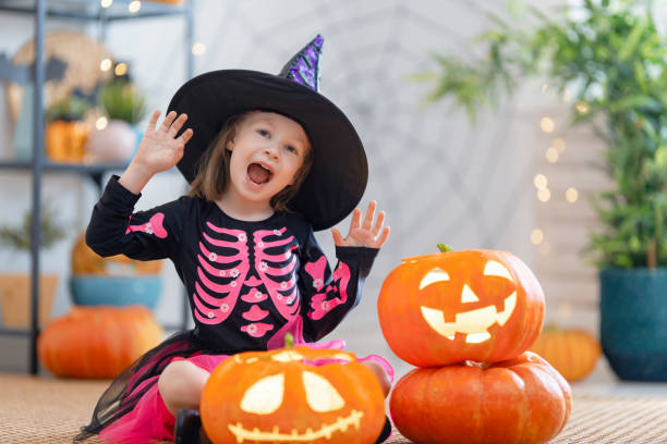 istock child with carving pumpkin 1279828559