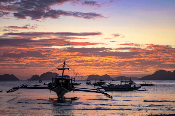 istock Fishing boats at sunset 1279828588