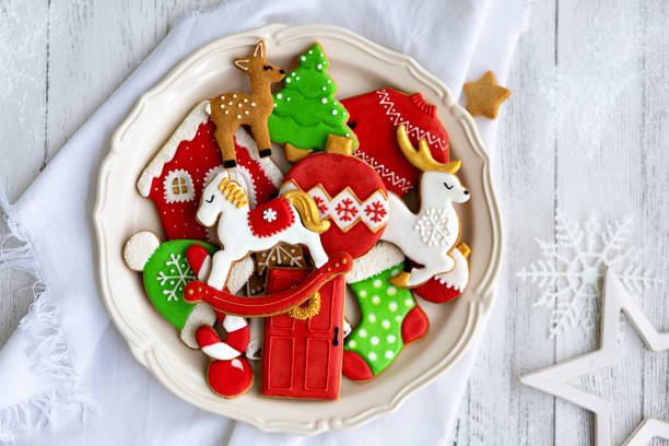 Iced gingerbread cookies Decorated gingerbread cookies on a plate white sugar cookie stock pictures, royalty-free photos & images