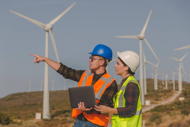 istock Young maintenance engineer team working in wind turbine farm 1279828927
