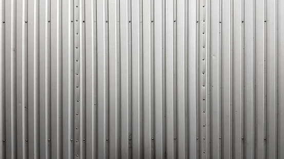 Corrugated sheet vertical metal texture background with rivets.