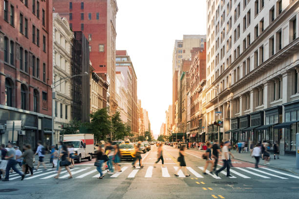 ニューヨーク市ミッドタウンマンハッタンの23丁目と5番街の交差点で忙しい横断歩道を歩く人々の群衆 - new york city manhattan built structure urban scene ストックフォトと画像