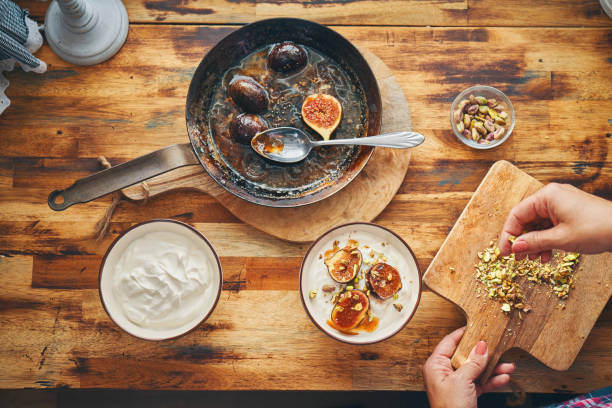 istock Preparing Yogurt with Caramelized Figs, Pistachio and Honey 1279831537