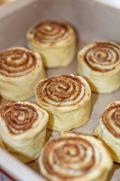 istock Rolled cinnamon dough on a baking sheet in the oven. 1279831550