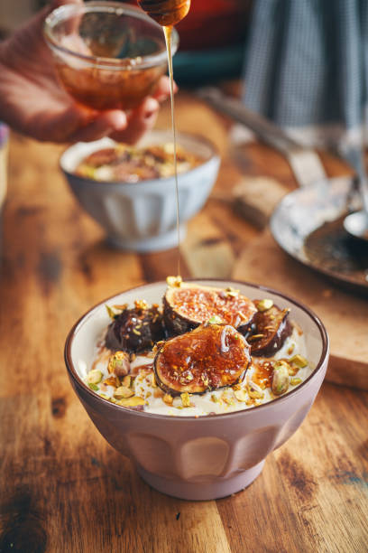 istock Preparing Yogurt with Caramelized Figs, Pistachio and Honey 1279831755