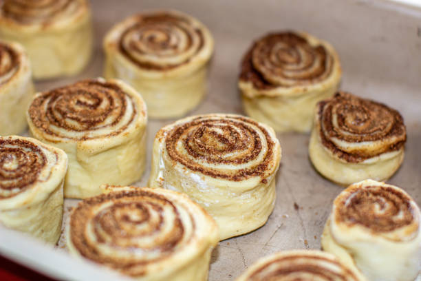 istock Rolled cinnamon dough on a baking sheet in the oven. 1279832350