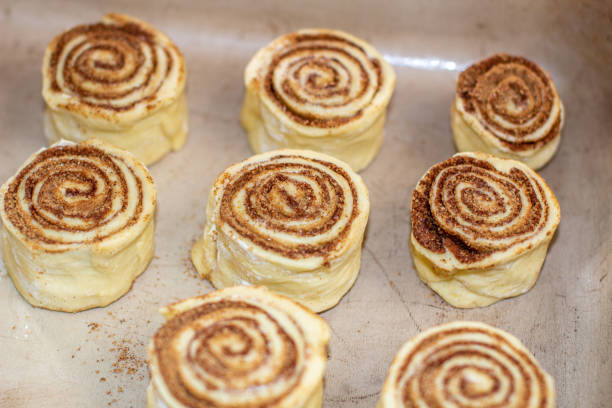 istock Rolled cinnamon dough on a baking sheet in the oven. 1279832499