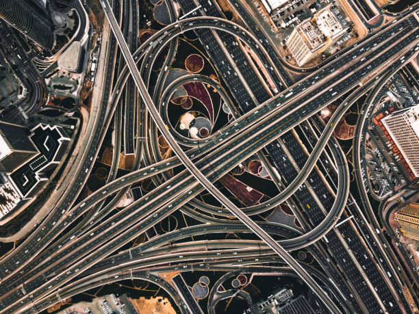 Drone Point View of Road Intersection / Dubai, UAE Drone Point View of Sheikh Zayed Road Intersection at Daytime / Dubai, UAE public transportation photos stock pictures, royalty-free photos & images